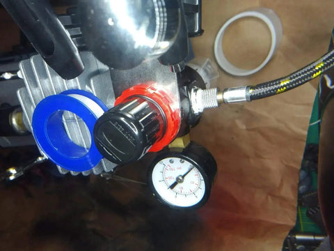 Pro Grade PTFE Thread Seal Tape For Plumbers 1 Inch By 520 Inch shown installed on a high pressure line with gauge and fittings.