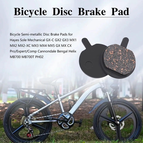 Front view of a pair of bicycle disc brake pads with black backing plates and copper-speckled friction material.