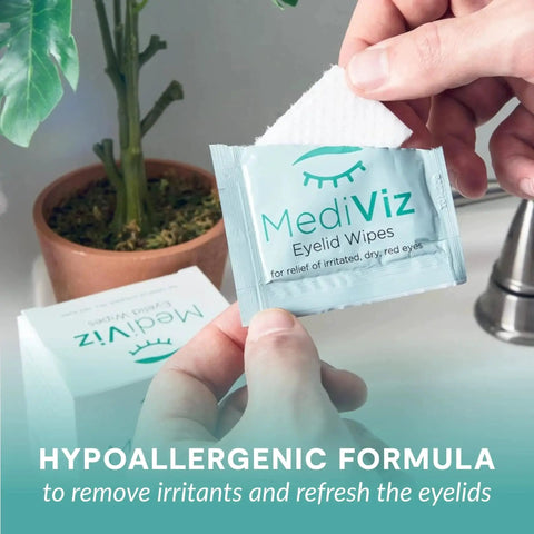 Person holding a packet of Hypoallergenic Eyelid Cleansing Wipes for Debris Removal and Itchy Eye Relief in front of a plant.
