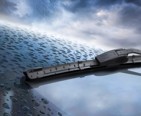 Water Repellent Glass Treatment For Rainy Day Driving That Boosts Visibility By Making Rain Bead Up And Slide Off The Windshield 473mL Bottle Rain X Original Glass Treatment on a windshield with droplets.
