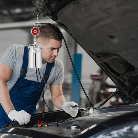 Man using 12V DC EVAP Smoke Machine Leak Detector for Quick Vacuum Leak Testing in Cars under open hood in garage.