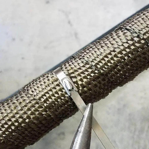 Close-up of 304 Stainless Steel Zip Tie 11.8 Inch Heavy Duty Built To Last Self Locking Cable Ties securing an exhaust wrap.