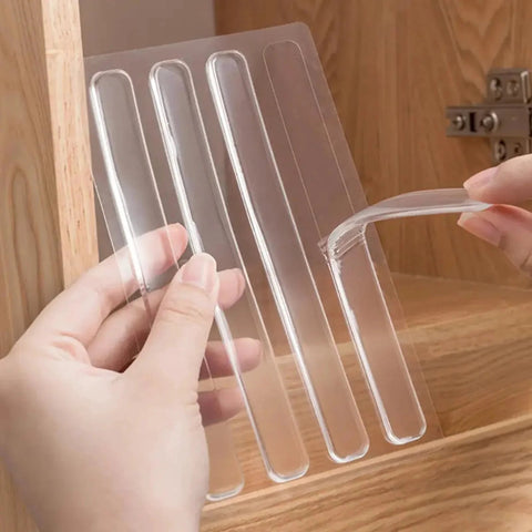 Hands holding and peeling off a clear silicone strip from a set of 100Pcs Self Adhesive Rubber Bumper Strips For Door Slam Prevention.