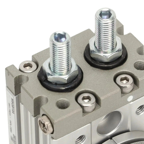 Close-up view of MSQB-10A pneumatic rotary actuator showing two threaded shafts and gray aluminum body.