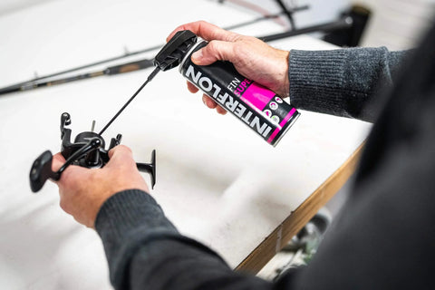 Person using Fin Super Industrial Oil Lubricant Spray With Penetrating Dry Film Action, Teflon Free And PFAS Free, 300ml aerosol on machinery part
