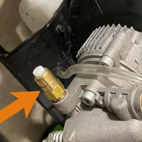 Thermal relief valve on pressure washer pump; brass body with white cap and clear hose.