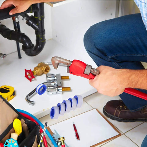 Plumber using wrench with Half Inch Teflon Plumber Tape 520 Inches Long 5.5 Mil PTFE Thread Seal Tape in a repair setup