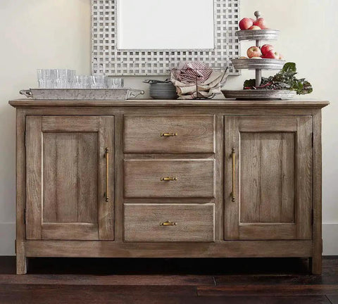 Front view of rustic sideboard with Six Pack 3 Inch Hole Center Cabinet Pulls Antique Brass Zinc Alloy Drawer Handles, decorated with glassware.