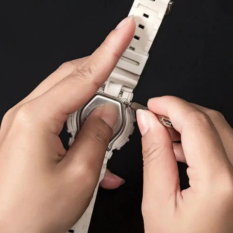 Using micro screwdriver from All In One Eyeglasses Repair Kit With 1100 Tiny Screws to adjust a watch, showcasing repair versatility.