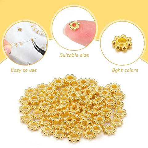 Close-up of gold flower spacer beads from 800 Pcs 6mm Flower Spacer Beads Multicolor Daisy Flower Metal Alloy Spacers Jewelry Kit.