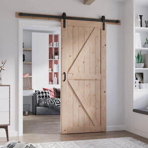 36 Inch By 84 Inch Wood Barn Door With Six Point Six Feet Hardware Kit Included K Shape Solid Spruce Panel Interior Sliding Door For Home Or Office Rustic Modern Look Easy Assembly Smooth Quiet Track System Durable Construction installed in a home interior.