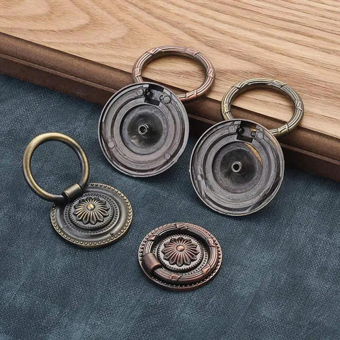 Vintage Oil Rubbed Bronze Ring Pulls for Cabinets and Drawers, 2 Inch Diameter, floral pattern variety laid on dark blue fabric