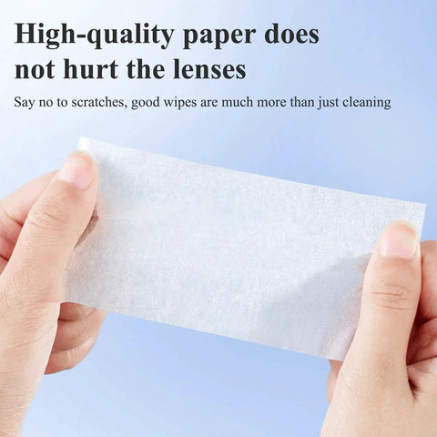 Hands holding single wipe from 320 Premoistened Cleaning Wipes For Glasses Screens And Cameras against blue background