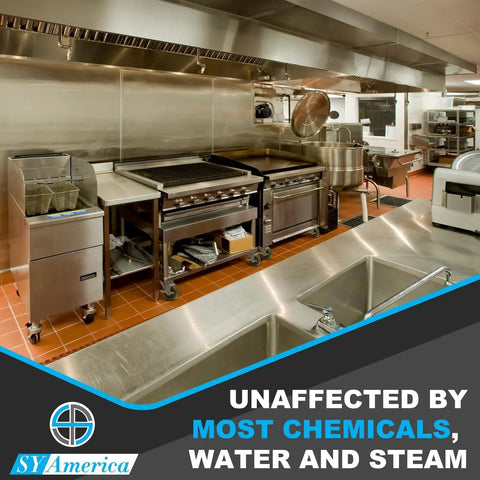 Commercial kitchen with stainless steel equipment, emphasizing durability against chemicals and steam.