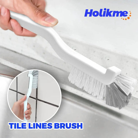 Hand holding a white brush from the 6 Pack Kitchen Brush Set Dish Brushes Scouring Pad Wire Brush Gap Brushes cleaning tile grout.