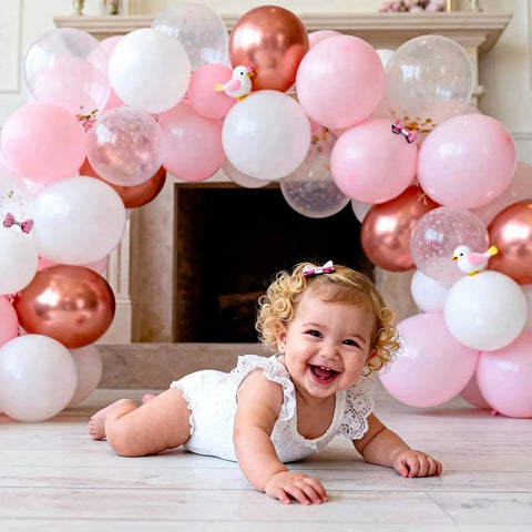 Smiling baby in front of pink and white balloon arch with gold accents; indoor setting; Bendable Balloon Arch Stand Kit 9ft And 5.6ft With Heavy Base Water Bag Gold not visible.