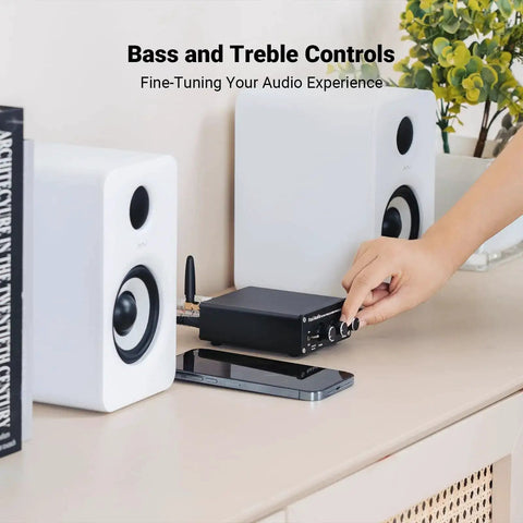 Bluetooth Stereo Amplifier 100W Per Channel, 2 Channel Class D Power Amp For Passive Speakers shown on a table with speakers.