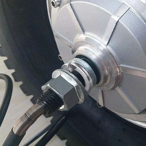 Spring lock washer on stainless steel bolt with hex nut attached to metal housing.