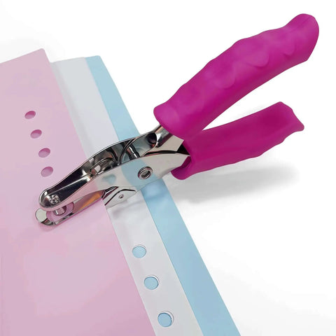 1/4 Inch Pink Handheld Circle Hole Punch for crafting punching paper on a table