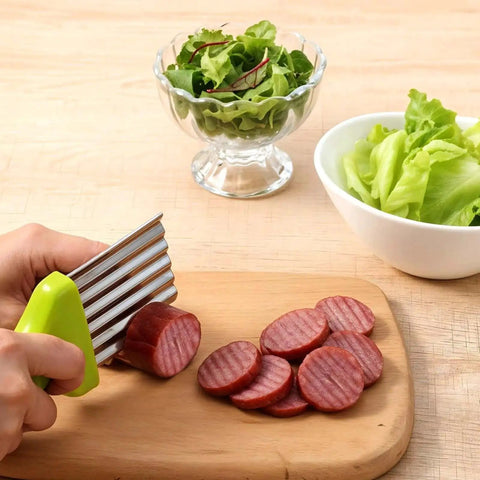 Hand using a 2 Pack Crinkle Cutter For Veggies And Fruits With Stainless Steel Wave Blade Durable Wavy Slicer cutting sausage
