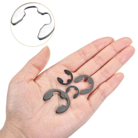 Hand holding 100 Pack External Retaining Rings 2mm 304 Stainless Steel E Clip Circlips Snap Rings for Valves