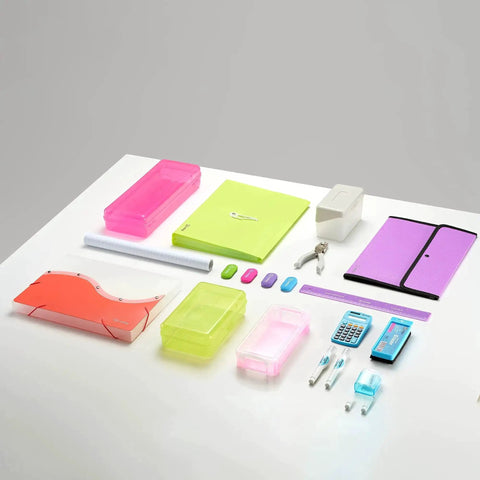 Assorted office supplies including neon folders, calculator, and stapler on a white desk