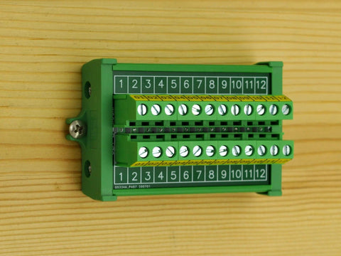 Durable Screw Mount Terminal Block Distribution Module, 12 Positions, 24A Per Position, 400V Rating, mounted on wood panel