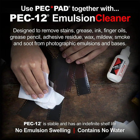 Hand using PEC-12 Emulsion Cleaner with wipe to clean photographic film, PEC*PAD display, focuses on removing stains, grease, and residue.