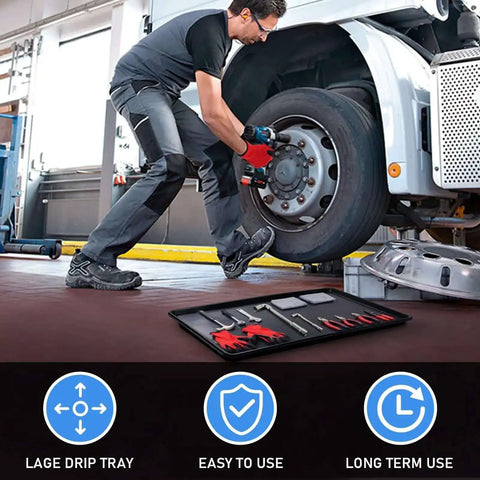 Mechanic using Triple Pack Extra Large Oil Drip Pan 35.4 X 24 Inch Heavy Duty Plastic Drain Tray under truck with tools and gloves.