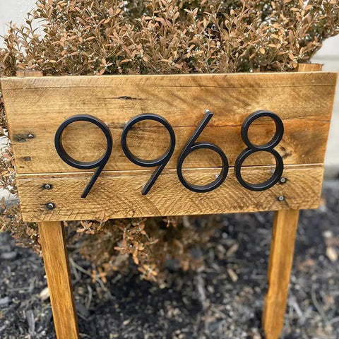 5 Inch Stainless Steel Floating House Number With Nail Kit Coated Black 911 Sign installed on a wooden board