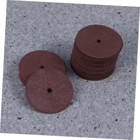Stack of grinding wheels from 36 Piece Heavy Duty Cutting Discs And Grinding Wheels Set For Metal, Wood, And Ceramics on grey surface.