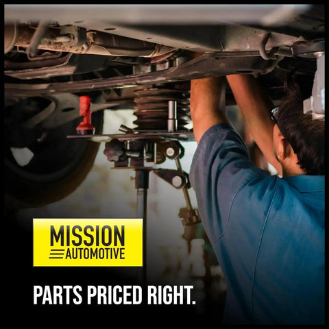 Mechanic working on vehicle undercarriage, Mission Automotive sign, parts priced right