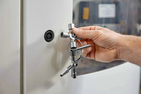 Hand using TwinKey Multifunctional Spanner Kit With Magnetic Eight Arm Two By Four Way Spider Keys on control cabinet