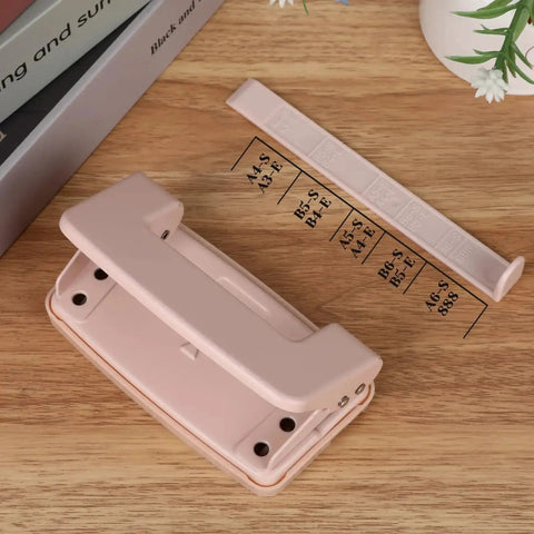 Pink Two Hole Punch With Ruler One Quarter Inch Punch for file folders and looseleaf, manual low force, holds up to ten sheets.