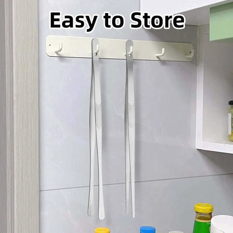12 Inch Stainless Steel Kitchen Tongs And Tweezers 2 Piece Set With Pro Grade Precision Serrated Tips hanging on wall hooks