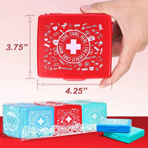 Hand holding Pocket Aid Mini First Aid Kit with 50 must-have items in a durable hard shell case, 24-pack by Everlit