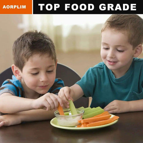 Two children enjoying carrot and celery sticks with dip at a table, focusing on playful snack time with healthy vegetables.