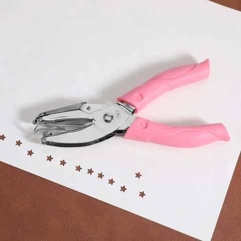 Star Shaped Hole Puncher With Soft Grip Handle Metal Single Hole Punch for crafts, shown with pink handle and star-shaped cutouts on paper