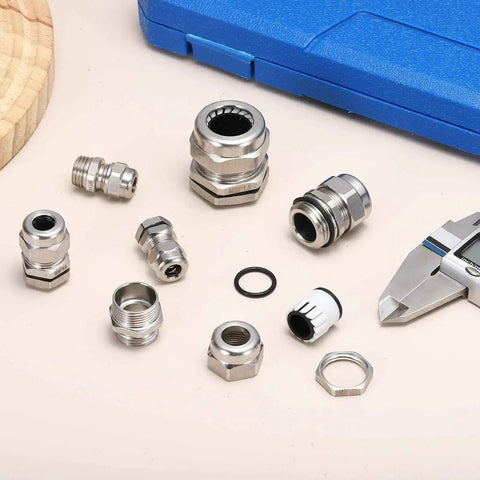 IP68 Waterproof and Heavy Duty PG11 Cable Gland for Five to Ten Millimeter Cables, stainless steel connectors displayed on table.