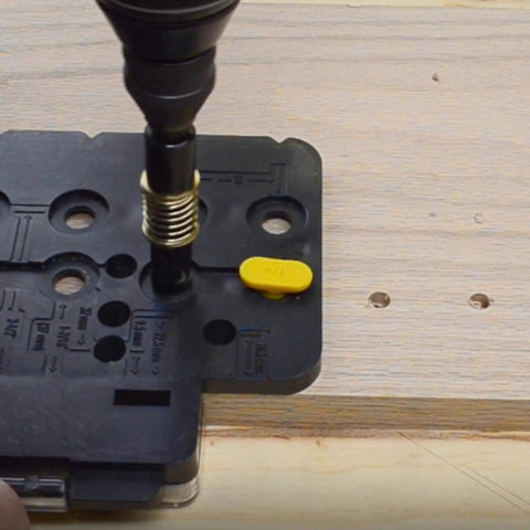 Close-up of Ultimate Cabinet Jig Bundle For DIYers with Cabinet Hardware Jig on wooden board in use.