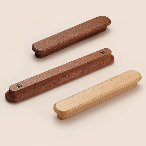 Three wooden drawer pulls in various brown tones on a beige background, not the Red Wood Round Wooden Drawer Knobs 5 Inch Single Hole shown.