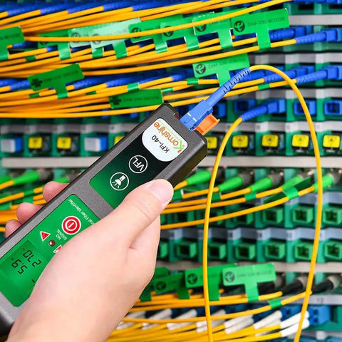 KFI-40 Fiber Optic Detector And Live Identifier testing cables, handheld tool in technician's hand at a panel with multiple fiber connections.