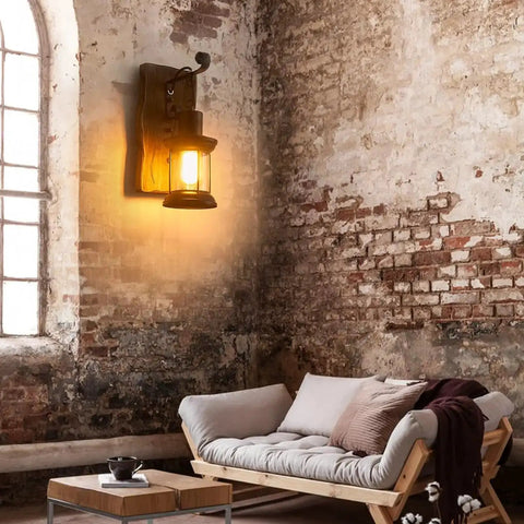 Set of Two Rustic Industrial Wall Sconces in Black Metal with Wood Backplate installed in a cozy living area with brick walls.