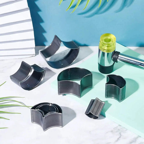 Leather Punch Die Set With 8 Fan Shaped Cutting Dies In High Carbon Steel for DIY Leather Craft displayed with mallet on table.
