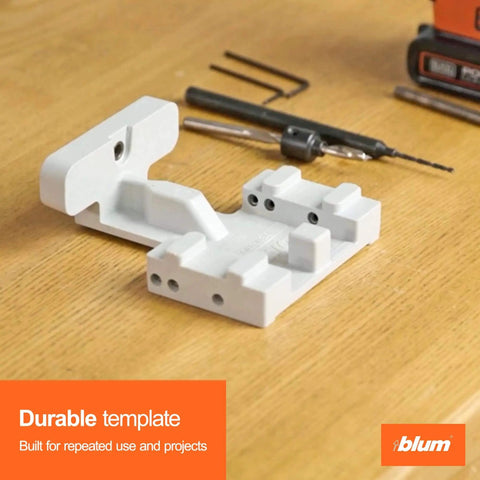 Precision drilling template for concealed undermount drawer runners that simplifies installation, with tools on wooden surface