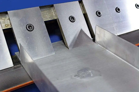 Close-up of the 48 Inch Pan And Box Sheet Metal Brake with adjustable removable fingers, showing a precise 135 degree bend in metal.