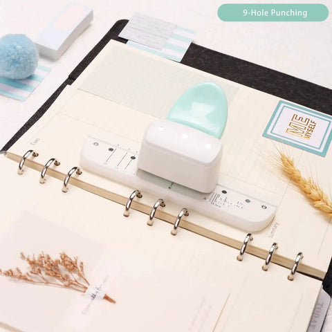 Go To 3 Hole Punch And 12 Piece Metal Ring Binder Set for A5 to A8 notebooks with white puncher and notebook on desk