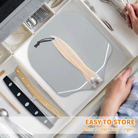 Pizza Peel And Rocker Cutter Set For Home Kitchen With Aluminum Paddle 12 By 14 Inches And Four 14 Inch Rocker Cutters, stored in drawer.