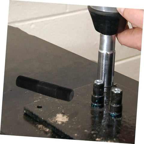 Close-up of Hydraulic Punch Driver Kit Pro Grade Knockout Tool Set for metal conduit and sheet punching in use on a workbench.