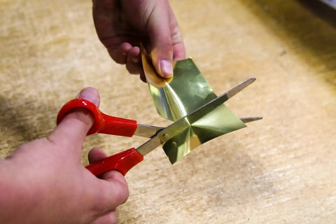 Cutting a brass sheet from the Assorted Brass Sheet Shim Set for Hobbyists and Model Builders, 24 Piece Kit of Easy Bend Brass Spacers.